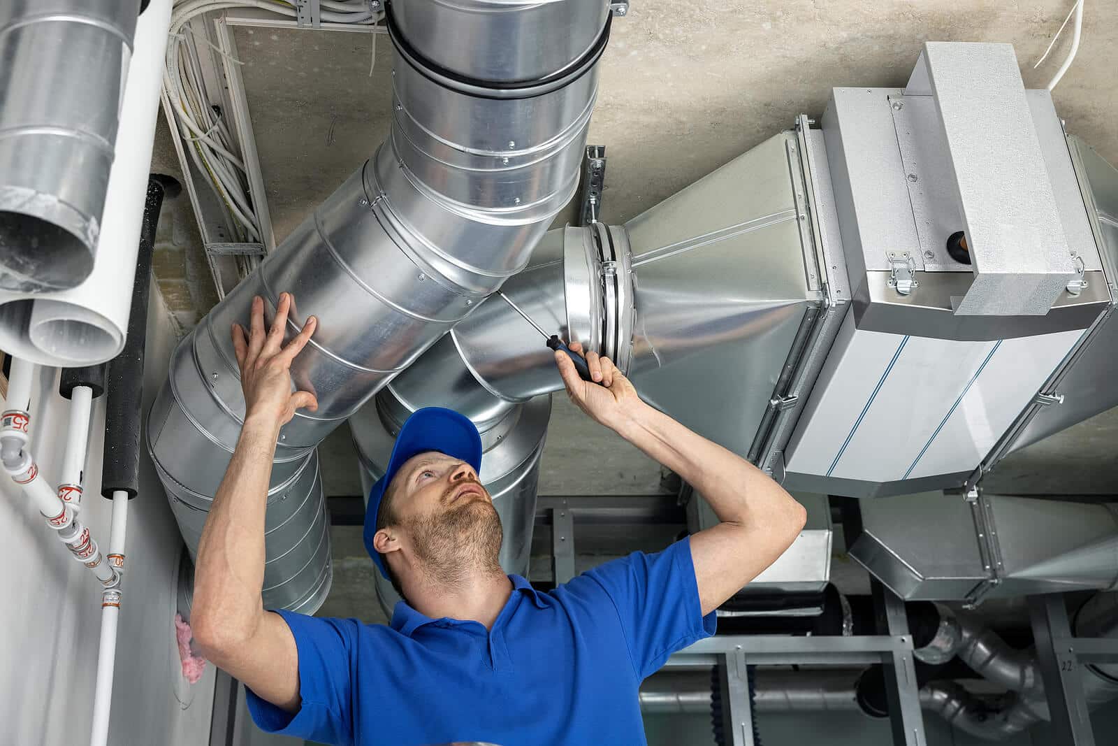 HVAC technician inspecting and repairing air ducts in Newport Beach