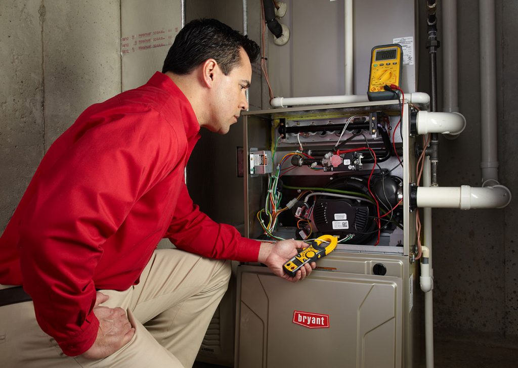 Heating technician diagnosing a furnace repair in Newport Beach