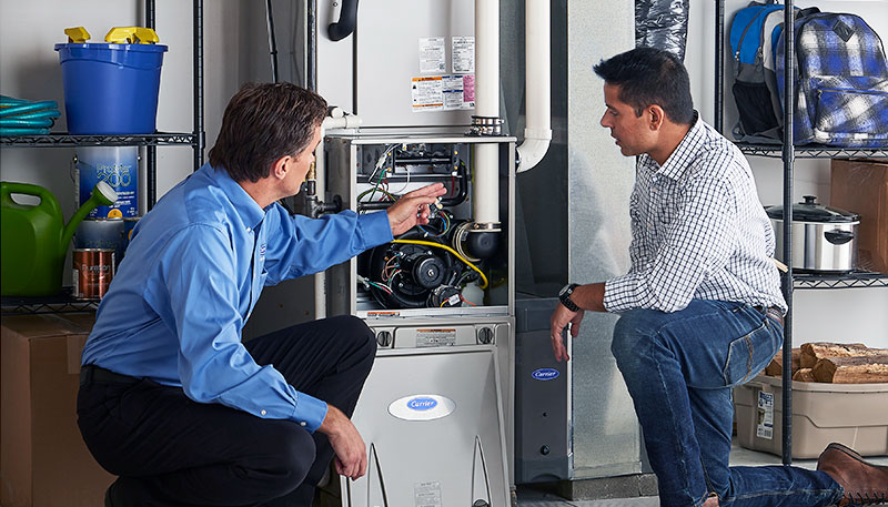 Technician evaluating a furnace for repair or replacement in Newport Beach