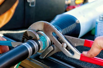 Technician repairing an industrial pipe connection in Newport Beach