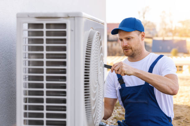 HVAC technician servicing an outdoor air conditioner in Newport Beach