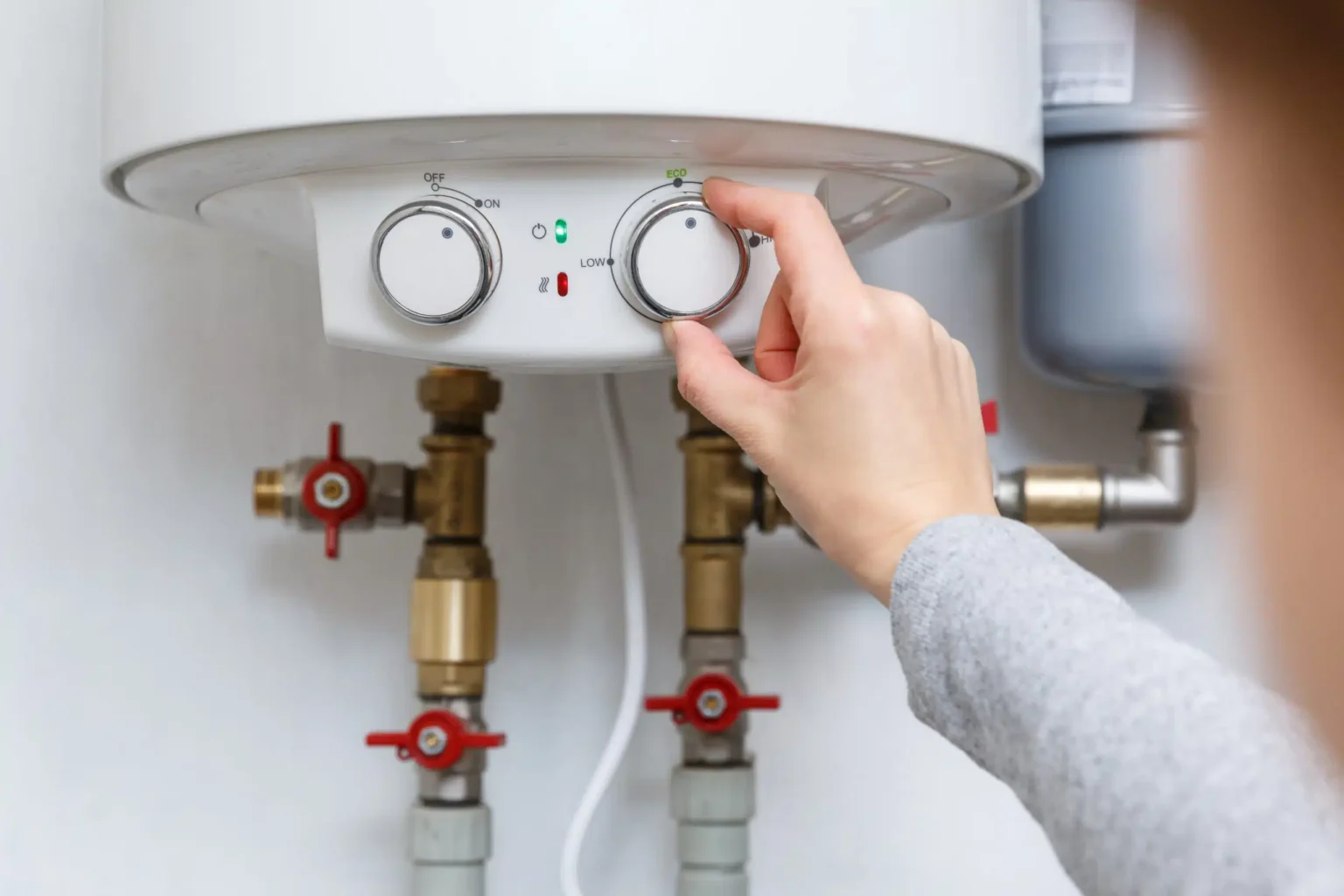 Technician adjusting a water heater in Newport Beach